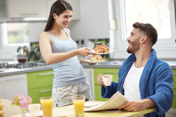 Young wife serving breakfast — Stock Photo, Image