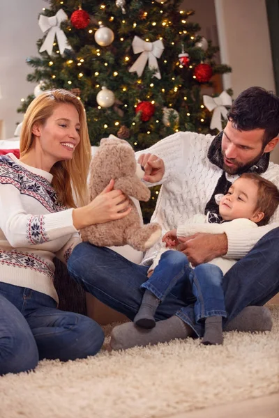 Happy Christmas  family playing with bear — Stock Photo, Image