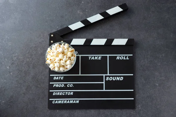 popcorn with movie maker or clapperboard cinema