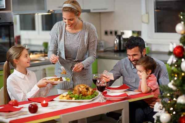 Happy family at the table having gala Christmas dinner — Stock Photo, Image