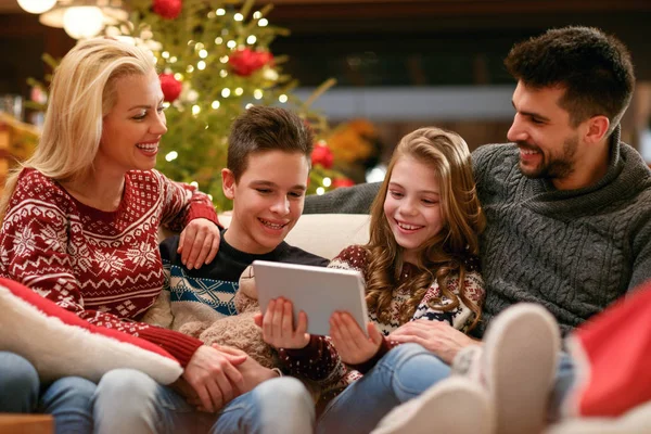 Children with parents on holiday watching photos — Stock Photo, Image