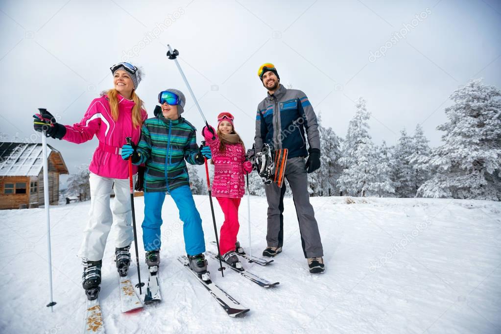 winter time and skiing family with ski and snowboard on ski