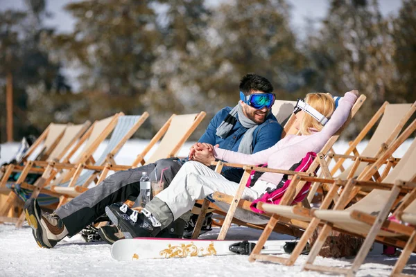 Pareja en el amor en las montañas en invierno riendo y relajarse en la cama solar — Foto de Stock