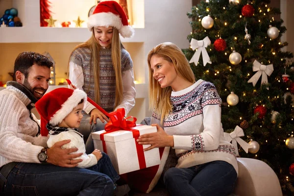 Boy receiving Christmas gift in big box from parents — Stock Photo, Image