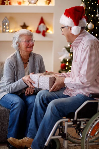 elderly couple sharing Christmas gift