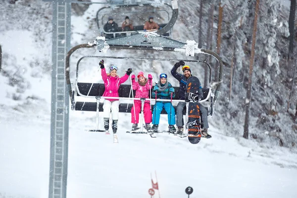 带着孩子的父母在滑雪椅上举起滑雪的地形 — 图库照片