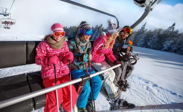 Family going on ski terrain with ski lift — Stock Photo, Image