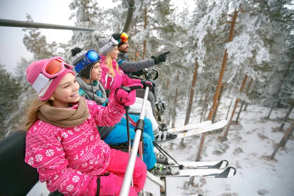 Vrouw en man met kinderen tillen op ski-terrein — Stockfoto