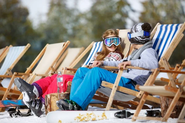 Children enjoys in sun lounger on ski terrain — Stock Photo, Image