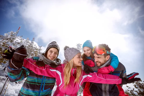 Woman with family having fun on skiing — Stock Photo, Image