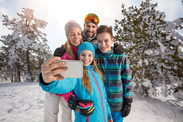 Ouders met kinderen nemen selfie op skiën — Stockfoto