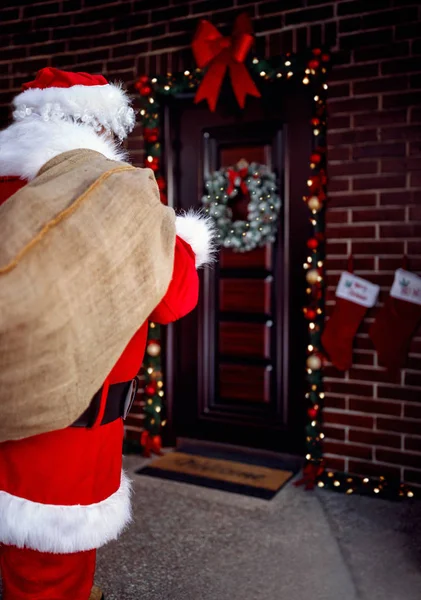 Santa Claus carrying bag with present for children in night — Stock Photo, Image