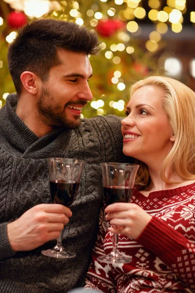 Romantic couple celebrating Christmas toasting with glasses — Stock Photo, Image