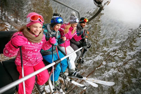 Skiing, ski lift, ski resort - happy family skiers on ski lift — Stock Photo, Image