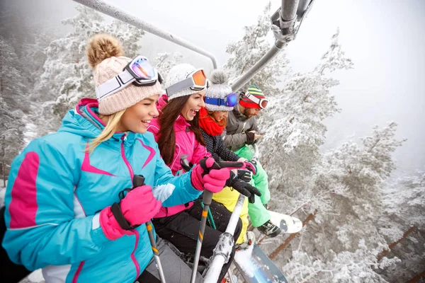 Friends in ski lift on mountain — Stock Photo, Image