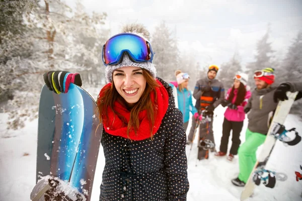 Sporty female holds snowboard in mountains on winter — Stock Photo, Image