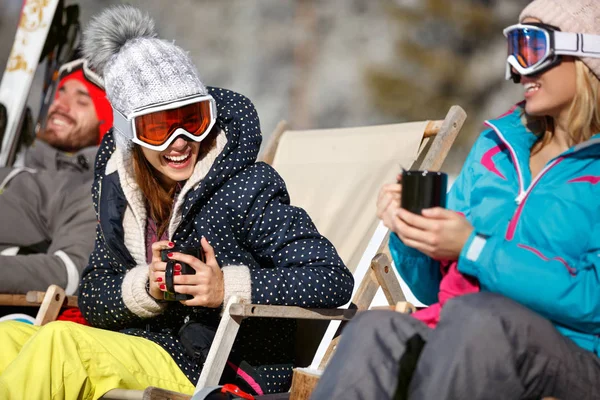 Mujeres juntas tomando el sol y bebiendo en la cafetería en el terreno de esquí — Foto de Stock