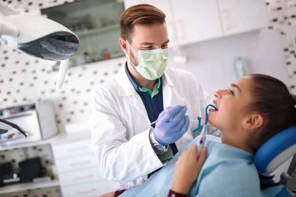 Стоматолог ремонтує зуб дівчини — стокове фото