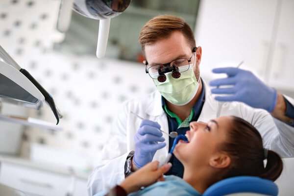 Dentist repair teeth to female patient