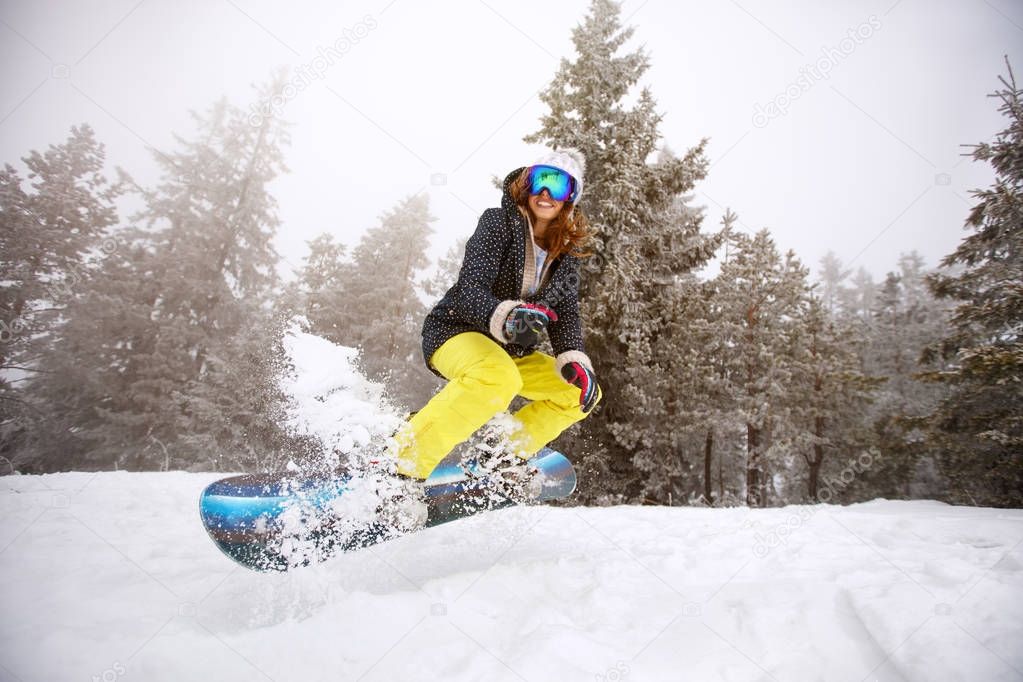 Trained woman snowboarding and jumping