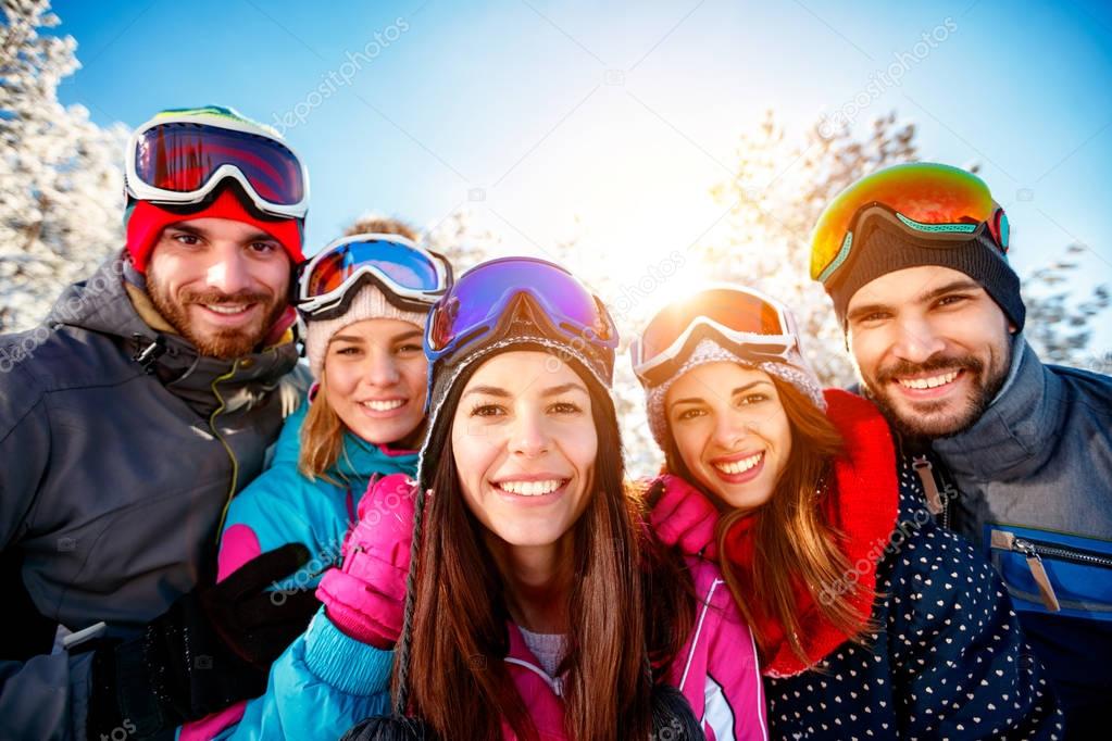 portrait group of friends skiers on winter holidays