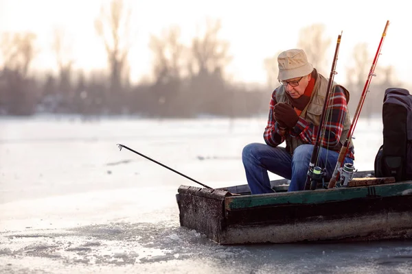 Temporada de inverno- homem de pesca no rio congelado — Fotografia de Stock