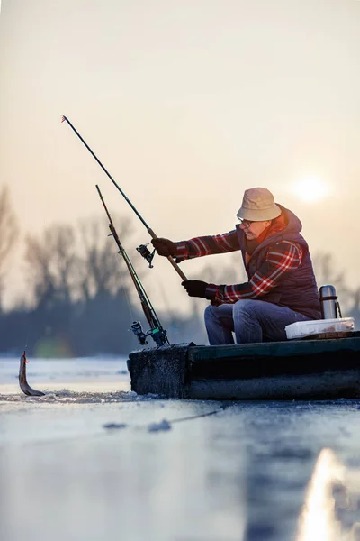 Fishing on frozen lake- Happy fisherman catch fish — Stock Photo, Image