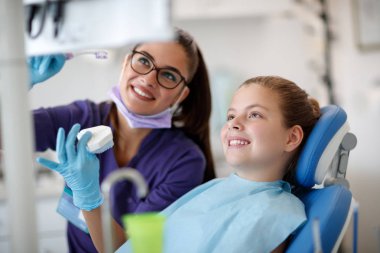 Dentist talk about cleaning jaw with patient  clipart