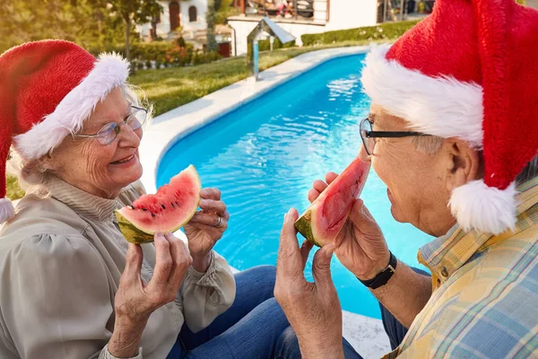 Anziani coppia godendo in anguria e celebrare il Natale — Foto Stock