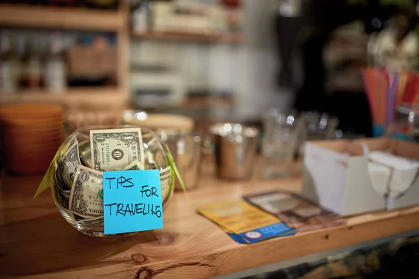 Glass bowl full of tips for traveling — Stock Photo, Image