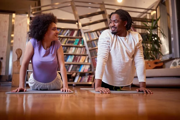 Couple  exercising doing yoga together at home — Stock Photo, Image