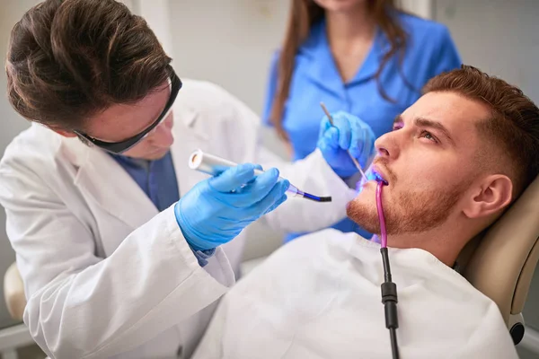 Dentista no trabalho em clínica odontológica — Fotografia de Stock