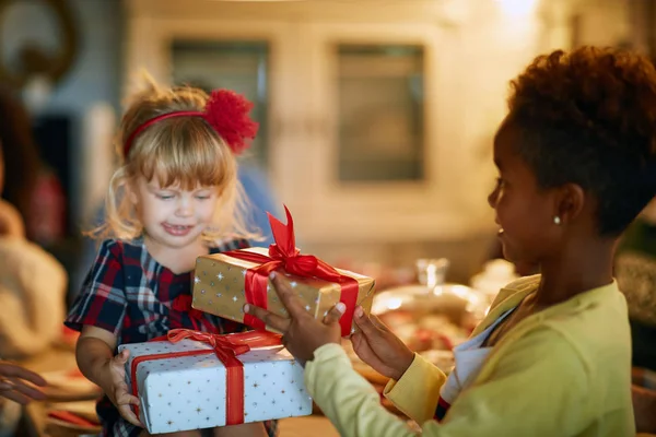 Future best friends exchanging Christmas gifts — Stock Photo, Image