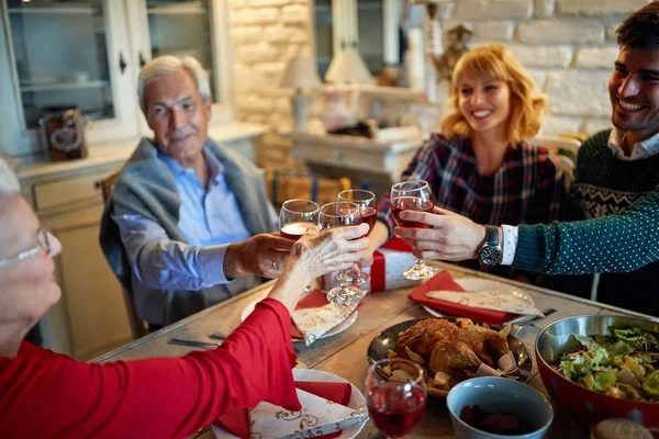 Holding glasses and cheering for Xmas — Stock Photo, Image