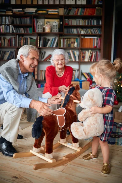 Christmas morning gift, rocking horse, grandparents — Stock Photo, Image