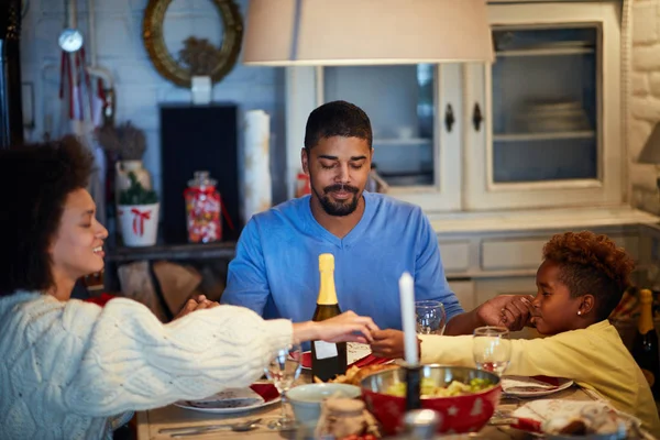 People having Christmas prayer for dinner at home — Stock Photo, Image
