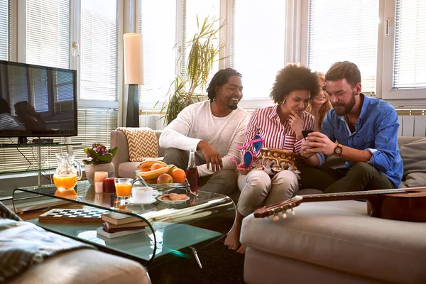 Group of people looking photo on cell phone — Stock Photo, Image