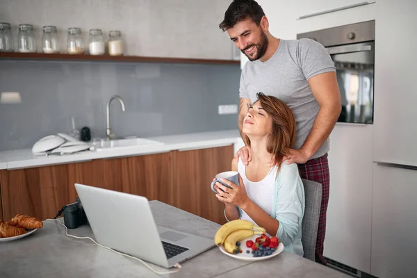 happy couple in kitchen enjoy together
