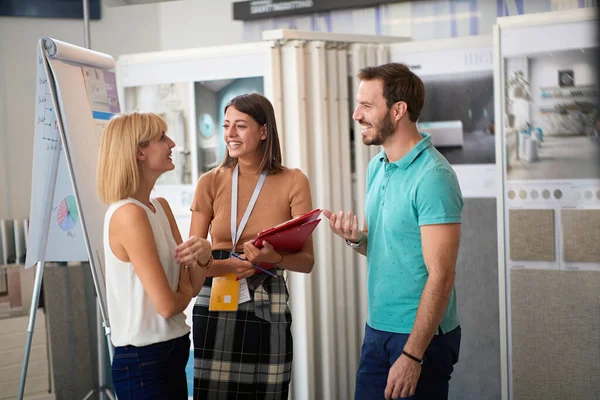 Jovem casal conversando com gerente de vendas abut decoração interior na loja de telhas cerâmicas . — Fotografia de Stock