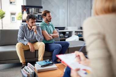 Dissatisfied with the solution to buy.Gay couple at purchases in