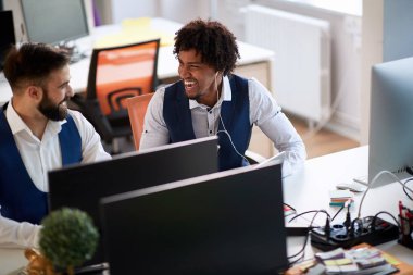 two colleagues talking and laughing in modern office. casual, fu