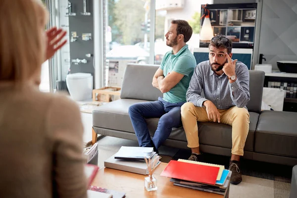 dissatisfied customer with salesman in store for the house.