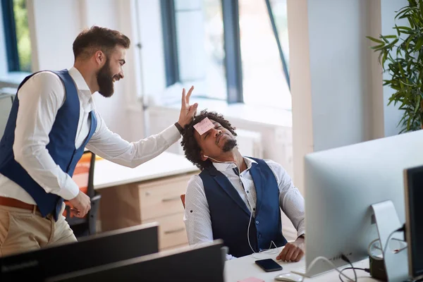 Colleague making joke with a boss sleeping at work in office. fu — Stockfoto