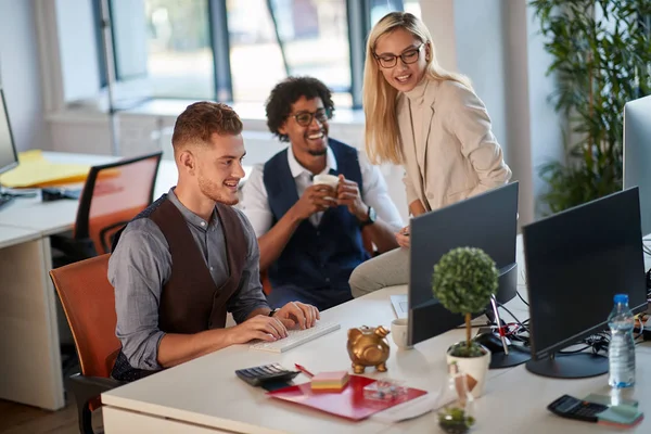 Tres colegas viendo y analizando el contenido en moni ordenador — Foto de Stock