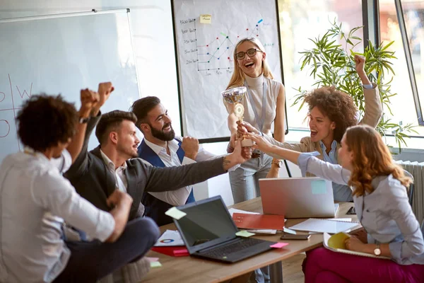 colleagues celebrating at office for wining top place at busines