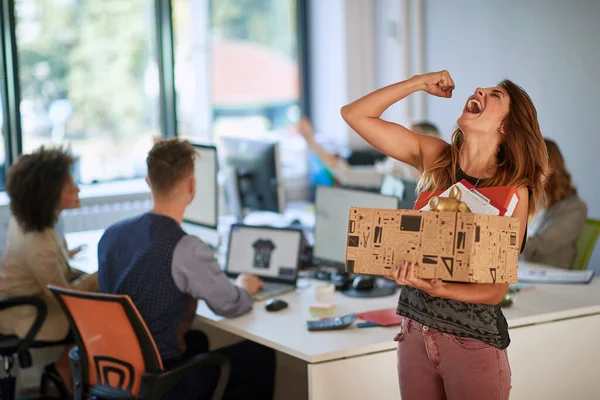 Happy successful modern  woman moving box with stuff at new modern business company.