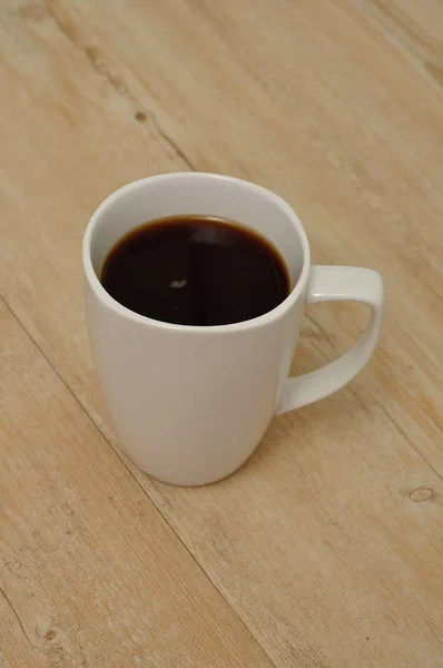 Black mug of coffee — Stock Photo, Image