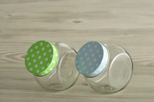 Empty glass jars with polka dot lids — Stock Photo, Image