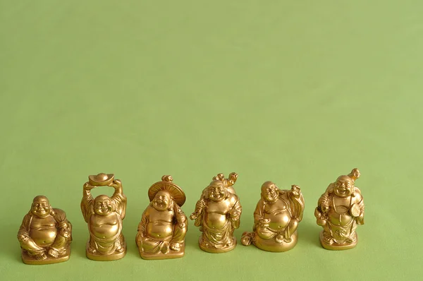 Figurer av en skrattande och glada gyllene Buddhas — Stockfoto