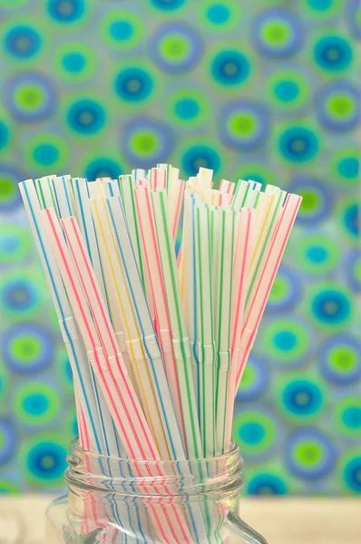 Drinking straws in a bottle with a colorful background — Stock Photo, Image